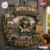 Notre Dame Fighting Irish Football Decorative Wreath with a leprechaun figure, team helmet, and stadium background on a door.