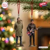 Oasis Advent Calendar 2026 hanging ornaments featuring Liam and Noel Gallagher figurines on a Christmas tree background.