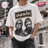 Front view of a white t-shirt featuring an Oasis band logo and black and white portraits of two men in leather jackets.