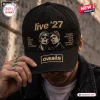 Front view of a black baseball cap featuring embroidered Oasis Live 27 text and graphic portraits.