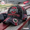 Front view of an Ohio State Buckeyes camo baseball cap with red accents and a buckeye leaf emblem on the bill.