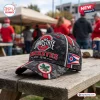 Side view of an Ohio State Buckeyes camo baseball cap with a state flag patch sitting on a weathered wooden table.