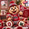 Front view of an Ohio State Buckeyes crochet mascot plush doll holding a miniature team pennant and a football.