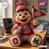 Front view of an Ohio State Buckeyes crochet mascot plush doll holding a small pennant flag and a stuffed football.