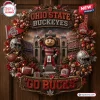 Ohio State Buckeyes Go Ducks Decorative Wreath featuring Brutus mascot, football helmets, red leaves, and stadium background.