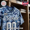 Old Dominion Monarchs custom camo football jersey in shades of blue and white hanging in a wooden locker room.
