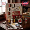 Peanuts 75th Anniversary 24-Piece Christmas Advent Calendar with Snoopy figures, star graphics, and red opening doors.
