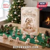 Pearl Dachshund Christmas Ornament Advent Calendar 2026 box with 24 individual miniature dog figures on a wooden table.