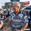 Older man smiling while wearing a blue and white Hawaiian shirt with Penn State Nittany Lions football graphics.