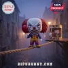 Pennywise x Cheshire Cat 1946-2006 Memorial Vinyl Figure standing on a rope holding a red balloon in a foggy street setting.
