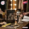 Figure of Phantom and Christine Daaé beside their anniversary display box on a vanity table.