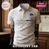 Phi Beta Sigma White Checkered Polo Shirt with blue Greek letter crest, button collar, and Sigma text on a wooden shelf.