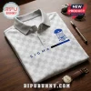 Phi Beta Sigma White Checkered Polo Shirt featuring the fraternity crest, blue Sigma text, and a gray collar on wood desk.