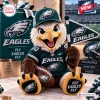 Front view of an eagle mascot plush doll wearing a jersey, cap, and holding a pennant and football.