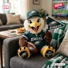 Front view of a Philadelphia Eagles crocheted plush doll wearing a jersey and cap while holding a pennant and football.