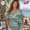 Woman wearing a Philadelphia Eagles Fly Eagles Fly Hawaiian shirt with a tropical and stadium graphic print.