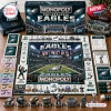 Top-down view of Philadelphia Eagles Monopoly board game including custom tokens, play money, and game board components.