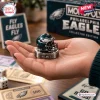 Close up of a hand holding a Philadelphia Eagles Monopoly board game metal helmet game piece.