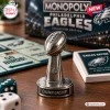 Close-up of a silver football trophy game piece on a Philadelphia Eagles Monopoly board game surface.