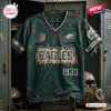 Front view of a green Philadelphia Eagles football t-shirt featuring distressed patches and 1933 branding.