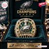 Close-up of a Philadelphia Eagles Super Bowl Championship Ring displayed inside a dark green velvet case.