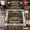 Top view of a Pittsburgh Steelers Monopoly board game layout showing the game board, tokens, cards, and game pieces.