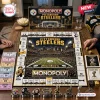 Top-down view of a Pittsburgh Steelers Monopoly board game laid out on a wooden table with game pieces and currency.