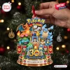 Hand holding a decorative 30th Anniversary Christmas ornament featuring a character seated with various creature figures.