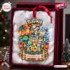 Front view of a Pokémon 30th Anniversary Christmas ornament featuring multiple creature figures and a gold base.