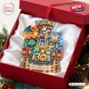 Close-up of a decorative Pokémon 30th Anniversary Christmas ornament featuring multiple character figures in a gift box.