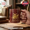 Pokemon 30th Anniversary Pikachu red coffee mug featuring gold emblem illustration in a library setting.