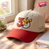 Front view of a beige baseball hat featuring a red brim and embroidered anniversary design.