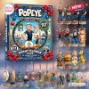Front view of the Popeye 97th Anniversary Advent Calendar packaging with figurine ornaments displayed around it.