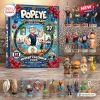 Front view of a Popeye 97th Anniversary Advent Calendar box with collectible character figures arranged below it.