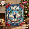 Front view of a blue festive box featuring cartoon characters, anchors, and ornaments for a 97th anniversary advent calendar.