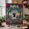 Front view of Popeye 97th Anniversary Advent Calendar box with nautical graphics and figurines on wooden table.
