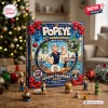 Front view of Popeye 97th Anniversary Advent Calendar box with festive bows and decorative ornaments on a wooden table.