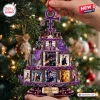 Close-up of a three-tiered tiered Prince iconic album covers Christmas ornament held in front of a tree.
