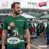 Front view of a man wearing a green Remembering Nick 1984-2025 tribute t-shirt with sports graphics.