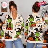 Front and back view of a woman wearing a cream Halloween cardigan with green character graphics and orange pumpkins.