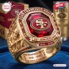 Detailed closeup of a gold San Francisco 49ers 80th anniversary ring with a central red stone.