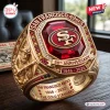 Close-up of a gold ring with a red gemstone, miner motif, and San Francisco 49ers 80th Anniversary text.
