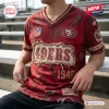Front view of a distressed red San Francisco 49ers NFL football t-shirt featuring frayed edges and a vintage patch.