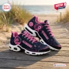 Side view of San Francisco 49ers x Breast Cancer Awareness Air Max Plus Sneakers on wooden boardwalk.