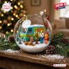 Front view of a clear glass ball ornament containing a miniature van and character figures on artificial snow.