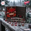 Front view of Slayer Christmas Advent Calendar blind box displayed outdoors on snowy wooden table with collectible metal ornaments.