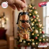 Snoop Dogg Hot Dog Christmas ornament featuring the rapper with sunglasses, braids, and a gold chain, held near a tree.