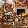 Front view of a 2026 Snoopy Halloween advent calendar box with hanging ornaments on a wooden table.