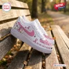 Side view of Snoopy Breast Cancer Awareness Air Force 1 Sneaker on wooden bench.