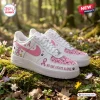 Side view of Snoopy Breast Cancer Awareness Air Force 1 Sneaker on mossy log.
